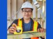 young man with safety helmet and glasses, measuring wood beam